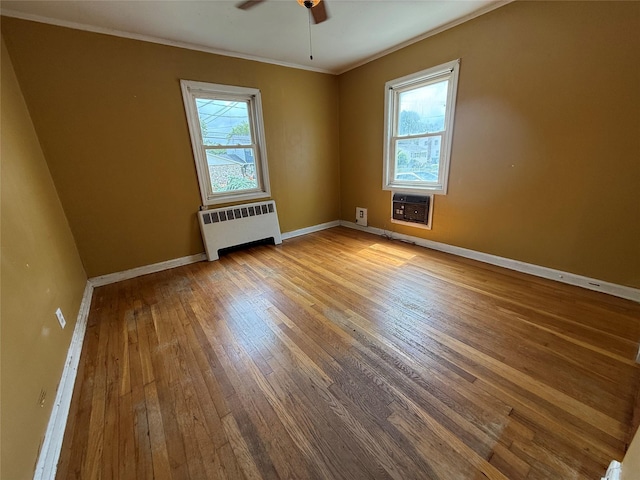 449 N Indiana Ave, Lindenhurst, NY 11757 - unfurnished room with radiator, ornamental molding, wood-type flooring, plenty of natural light, and a ceiling fan