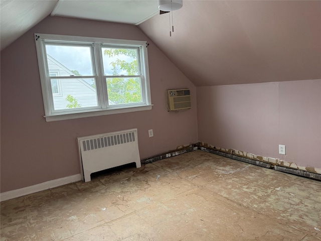 449 N Indiana Ave, Lindenhurst, NY 11757 - additional living space with radiator, a wall mounted AC, a ceiling fan, and vaulted ceiling