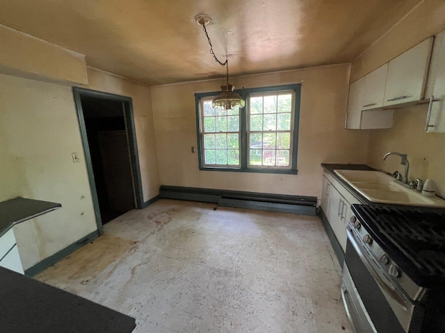 115 Chestnut Ave, New Windsor, NY 12553 - kitchen with stainless steel gas range oven, white cabinetry, a chandelier, unfinished concrete flooring, and a baseboard radiator