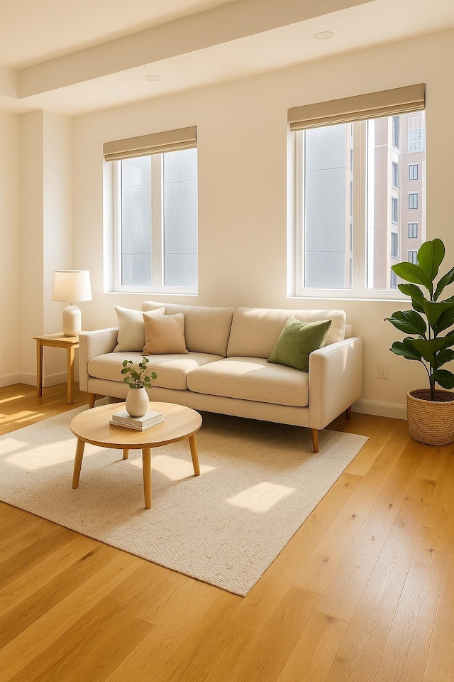 24-16 Queens Plz S Unit 4J, Long Island City, NY 11101 - living area featuring healthy amount of natural light and wood finished floors