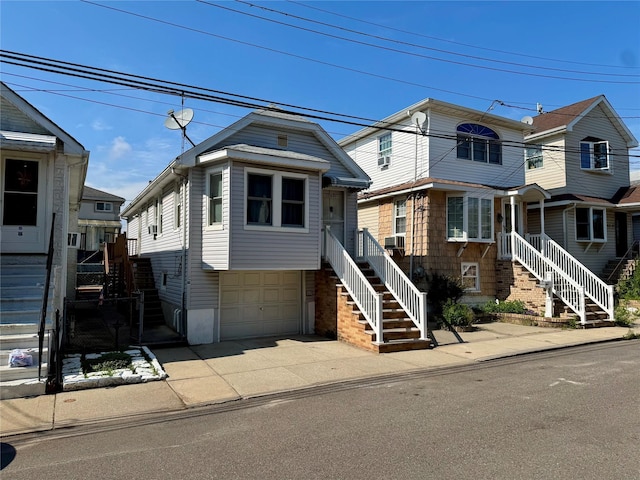 10221 Davenport Ct, Howard Beach, NY 11414 - view of front of property featuring stairway, an attached garage, and driveway