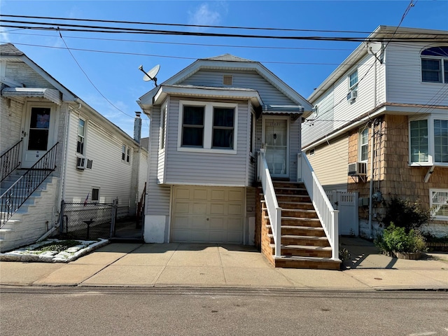 10221 Davenport Ct, Howard Beach, NY 11414 - view of front facade featuring stairway, a garage, cooling unit, a gate, and concrete driveway
