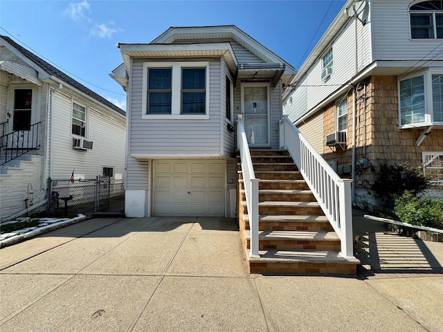 10221 Davenport Ct, Howard Beach, NY 11414 - view of front facade with a garage, driveway, cooling unit, and stairs