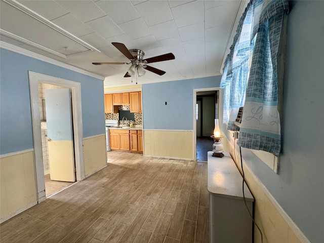10221 Davenport Ct, Howard Beach, NY 11414 - kitchen with a ceiling fan, wainscoting, ornamental molding, light wood finished floors, and light countertops