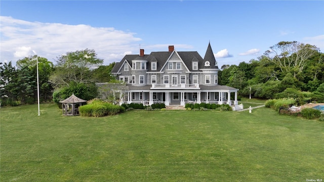 9 Convent Ln, Center Moriches, NY 11934 - view of front of property featuring covered porch, a chimney, and a front lawn