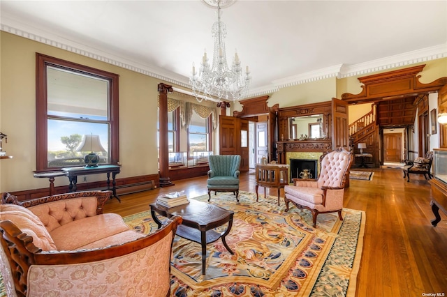 9 Convent Ln, Center Moriches, NY 11934 - living room with a chandelier, crown molding, a fireplace, and wood finished floors