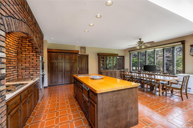 9 Convent Ln, Center Moriches, NY 11934 - kitchen featuring wood counters, recessed lighting, a center island, a ceiling fan, and appliances with stainless steel finishes