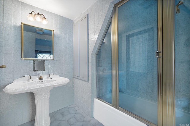 9 Convent Ln, Center Moriches, NY 11934 - full bath with tile walls, shower / bath combination with glass door, and tile patterned floors
