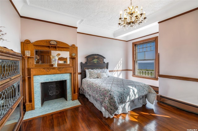 9 Convent Ln, Center Moriches, NY 11934 - bedroom with a chandelier, baseboard heating, wood finished floors, a tiled fireplace, and a textured ceiling