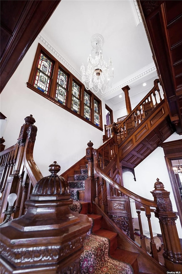 9 Convent Ln, Center Moriches, NY 11934 - staircase featuring a high ceiling, a chandelier, and crown molding