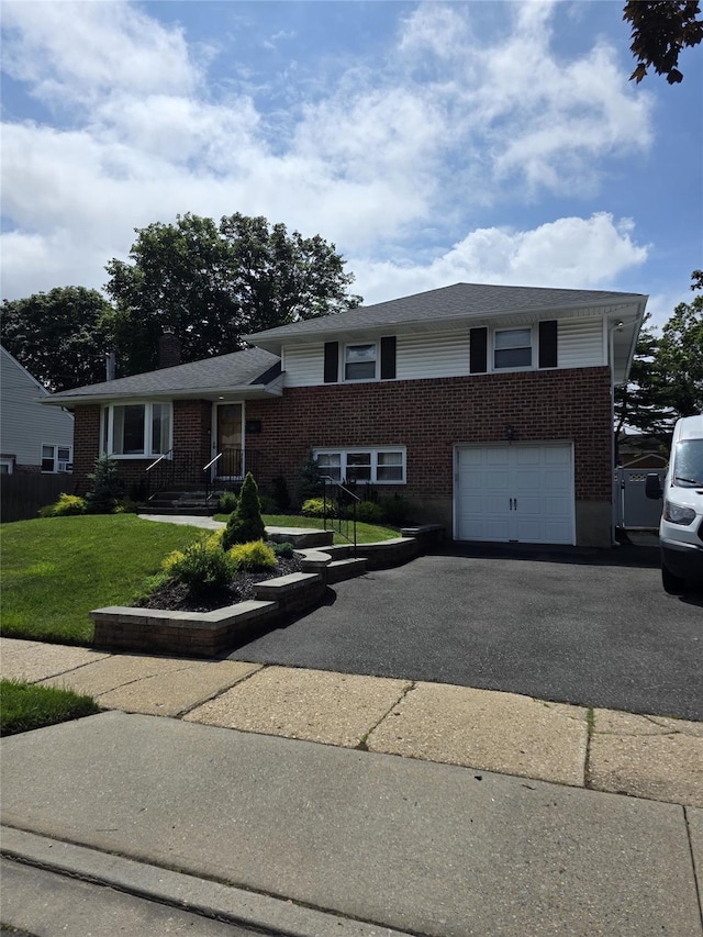 3 Lourae Dr, Massapequa Park, NY 11762 - tri-level home with brick siding, driveway, a front lawn, and an attached garage