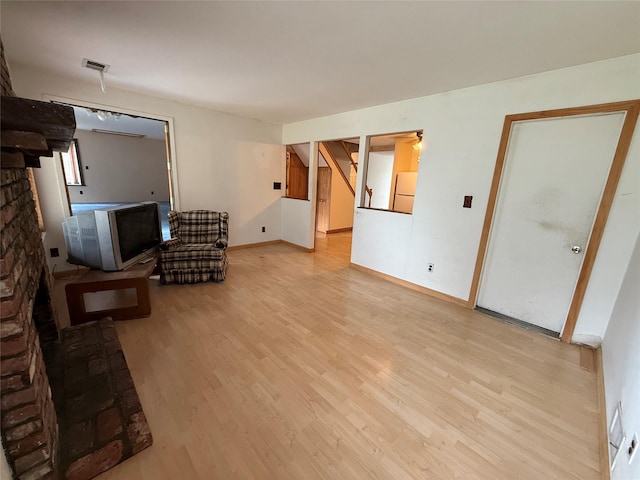 719 Greenbelt Pkwy W, Holbrook, NY 11741 - unfurnished living room with light wood finished floors and stairway