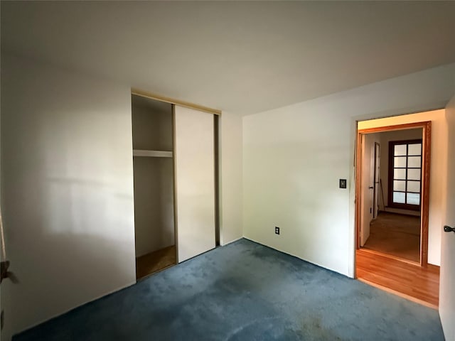 719 Greenbelt Pkwy W, Holbrook, NY 11741 - unfurnished bedroom featuring dark carpet and a closet