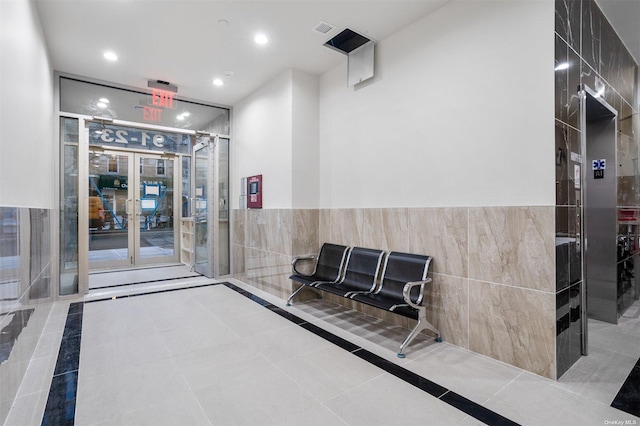 91-23 Corona Ave Unit 2B, Elmhurst, NY 11373 - building lobby with tile walls, recessed lighting, and a wainscoted wall