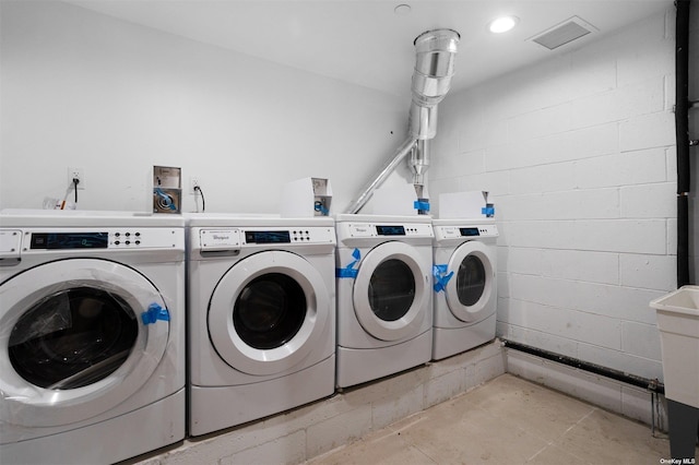 91-23 Corona Ave Unit 2B, Elmhurst, NY 11373 - community laundry room with independent washer and dryer and concrete block wall