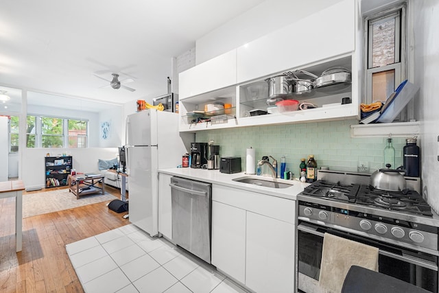 313 E 89th St Unit 2C, New York Manhattan, NY 10128 - kitchen with stainless steel appliances, ceiling fan, open shelves, and decorative backsplash