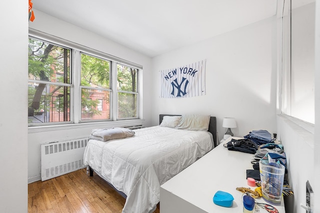 313 E 89th St Unit 2C, New York Manhattan, NY 10128 - bedroom with radiator heating unit and hardwood / wood-style floors