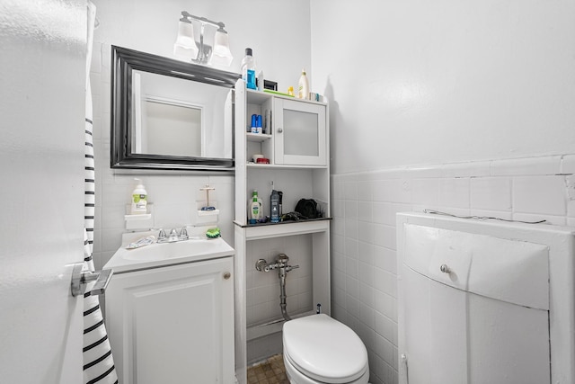 313 E 89th St Unit 2C, New York Manhattan, NY 10128 - half bath featuring tile walls, vanity, and wainscoting