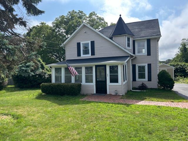 48 Senix Ave, Center Moriches, NY 11934 - view of front of house with a front yard and a sunroom