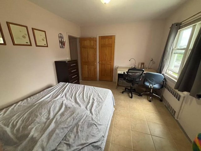 22-01 149th St, Whitestone, NY 11357 - bedroom with radiator heating unit and an office area