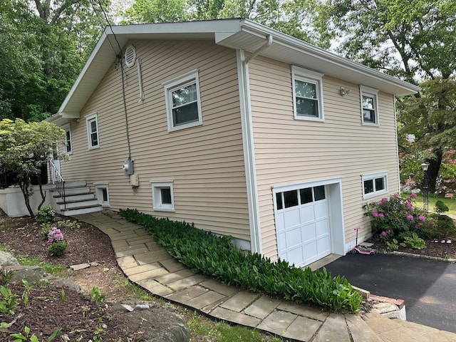 5 High St, Bedford Hills, NY 10507 - view of home's exterior featuring an attached garage and asphalt driveway