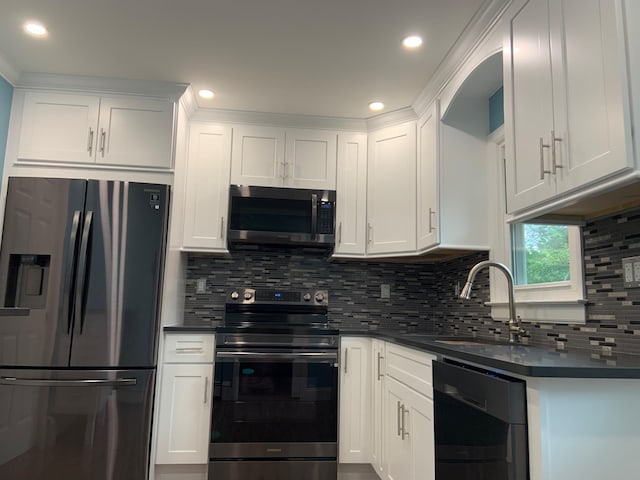 5 High St, Bedford Hills, NY 10507 - kitchen with stainless steel appliances, dark countertops, tasteful backsplash, white cabinetry, and recessed lighting