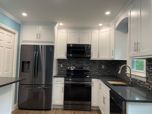 5 High St, Bedford Hills, NY 10507 - kitchen featuring appliances with stainless steel finishes, dark countertops, white cabinetry, backsplash, and light wood-type flooring