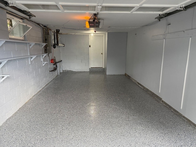 5 High St, Bedford Hills, NY 10507 - garage featuring concrete block wall, a garage door opener, and electric panel