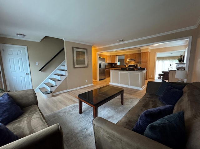 3805 Mansfield Dr, Seaford, NY 11783 - living room featuring light wood-type flooring, crown molding, and stairs