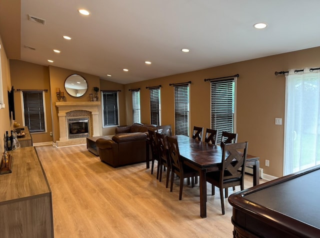 3805 Mansfield Dr, Seaford, NY 11783 - dining room featuring light wood-type flooring, recessed lighting, a fireplace, and lofted ceiling