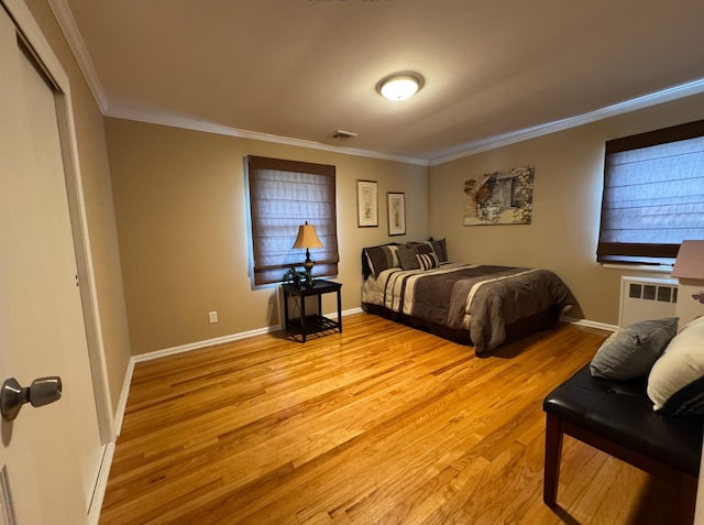 3805 Mansfield Dr, Seaford, NY 11783 - bedroom with radiator heating unit, ornamental molding, and light wood-type flooring