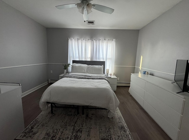 3805 Mansfield Dr, Seaford, NY 11783 - bedroom featuring a baseboard heating unit, wood finished floors, ceiling fan, and baseboard heating