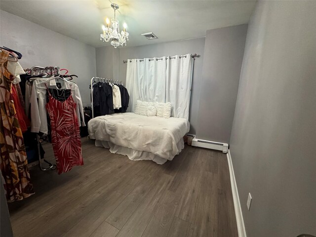 3805 Mansfield Dr, Seaford, NY 11783 - bedroom with a baseboard heating unit, dark wood-type flooring, and a chandelier