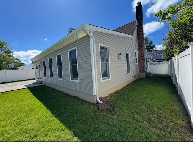 3805 Mansfield Dr, Seaford, NY 11783 - view of home's exterior featuring a fenced backyard, a chimney, and a patio