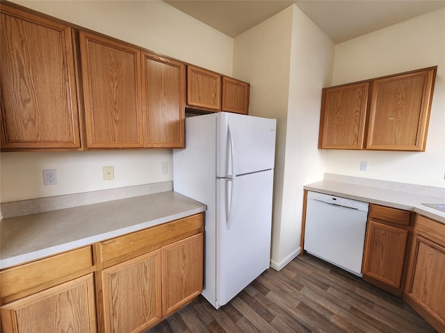 47 Pipetown Hill Radl, Nanuet, NY 10954 - kitchen featuring white appliances, dark wood-style floors, light countertops, and brown cabinetry