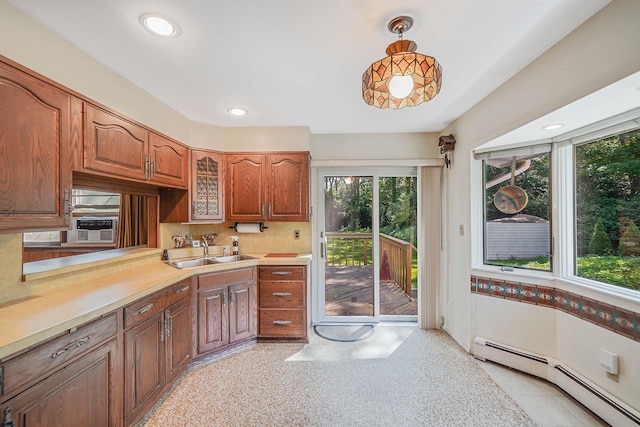 203 Deer Park Rd, Dix Hills, NY 11746 - kitchen with baseboard heating, light countertops, brown cabinetry, tasteful backsplash, and glass insert cabinets