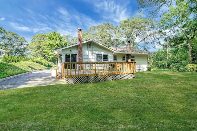 203 Deer Park Rd, Dix Hills, NY 11746 - rear view of house featuring a chimney, a wooden deck, and a yard