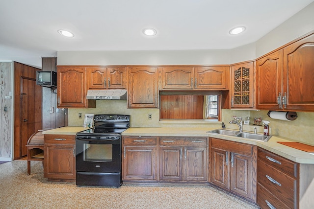 203 Deer Park Rd, Dix Hills, NY 11746 - kitchen with electric range, under cabinet range hood, light countertops, glass insert cabinets, and brown cabinets