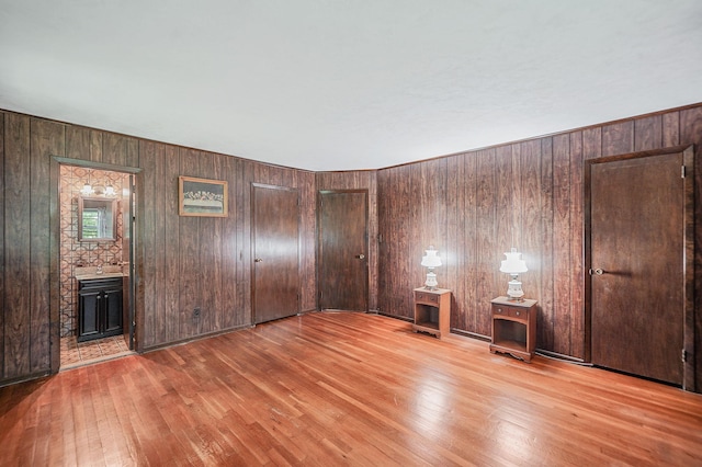 203 Deer Park Rd, Dix Hills, NY 11746 - spare room with wood finished floors and wood walls