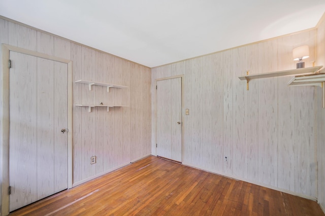 203 Deer Park Rd, Dix Hills, NY 11746 - unfurnished room with hardwood / wood-style floors and wood walls