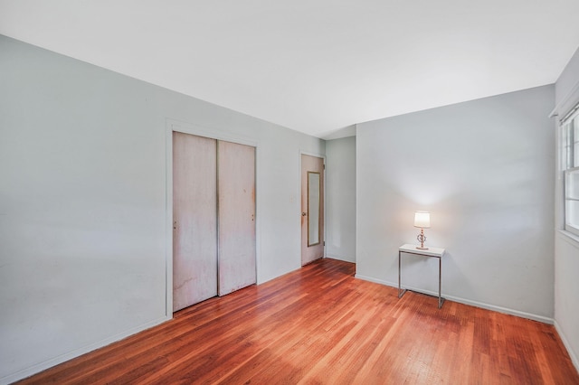 203 Deer Park Rd, Dix Hills, NY 11746 - unfurnished bedroom with wood finished floors and a closet