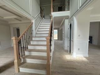 4 Kroll St, Plainview, NY 11803 - stairway featuring a decorative wall and a wainscoted wall
