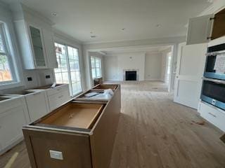 4 Kroll St, Plainview, NY 11803 - kitchen featuring a center island, healthy amount of natural light, a fireplace, open floor plan, and ornamental molding