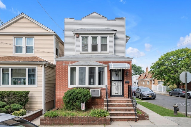 7609 79th St, Glendale, NY 11385 - view of front facade with brick siding and roof with shingles