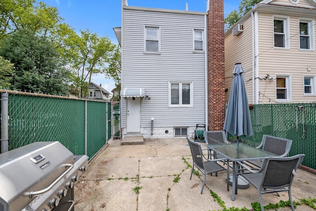 7609 79th St, Glendale, NY 11385 - back of property featuring a patio, a fenced backyard, outdoor dining area, and a wall unit AC