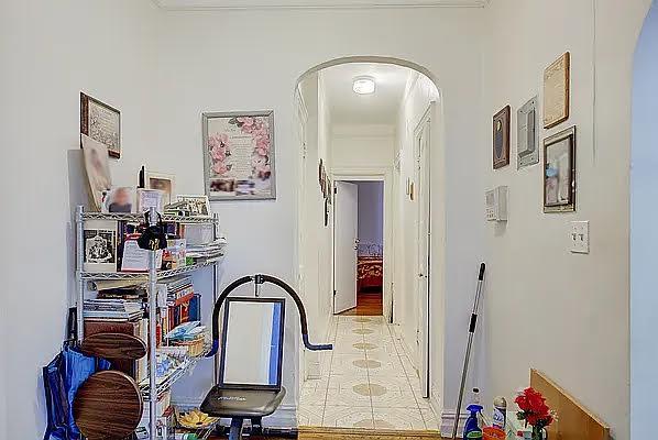 1304 Pacific St Unit B1, Brooklyn, NY 11216 - hallway with arched walkways, light tile patterned floors, and ornamental molding