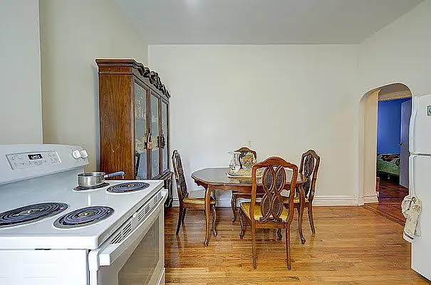1304 Pacific St Unit B1, Brooklyn, NY 11216 - dining space with arched walkways and light wood finished floors