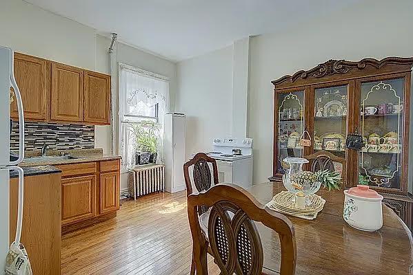 1304 Pacific St Unit B1, Brooklyn, NY 11216 - dining area featuring radiator heating unit and light wood-style flooring