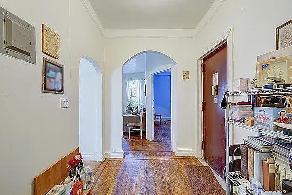 1304 Pacific St Unit B1, Brooklyn, NY 11216 - corridor with arched walkways, crown molding, and wood finished floors