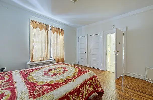 1304 Pacific St Unit B1, Brooklyn, NY 11216 - bedroom with wood finished floors, multiple closets, and radiator heating unit